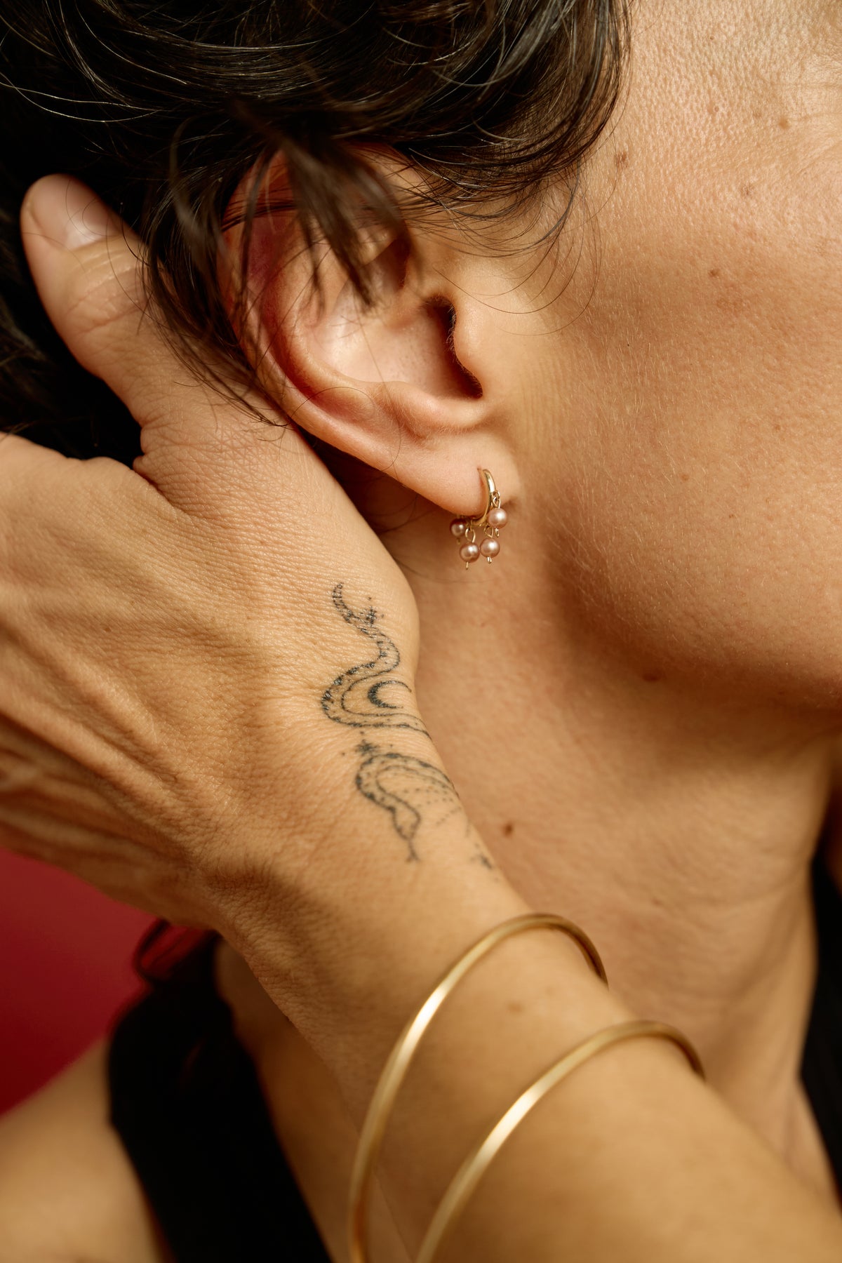 Malar Jhumka Hoops worn with gold bangles: pink pearl huggie earring in solid 14k gold
