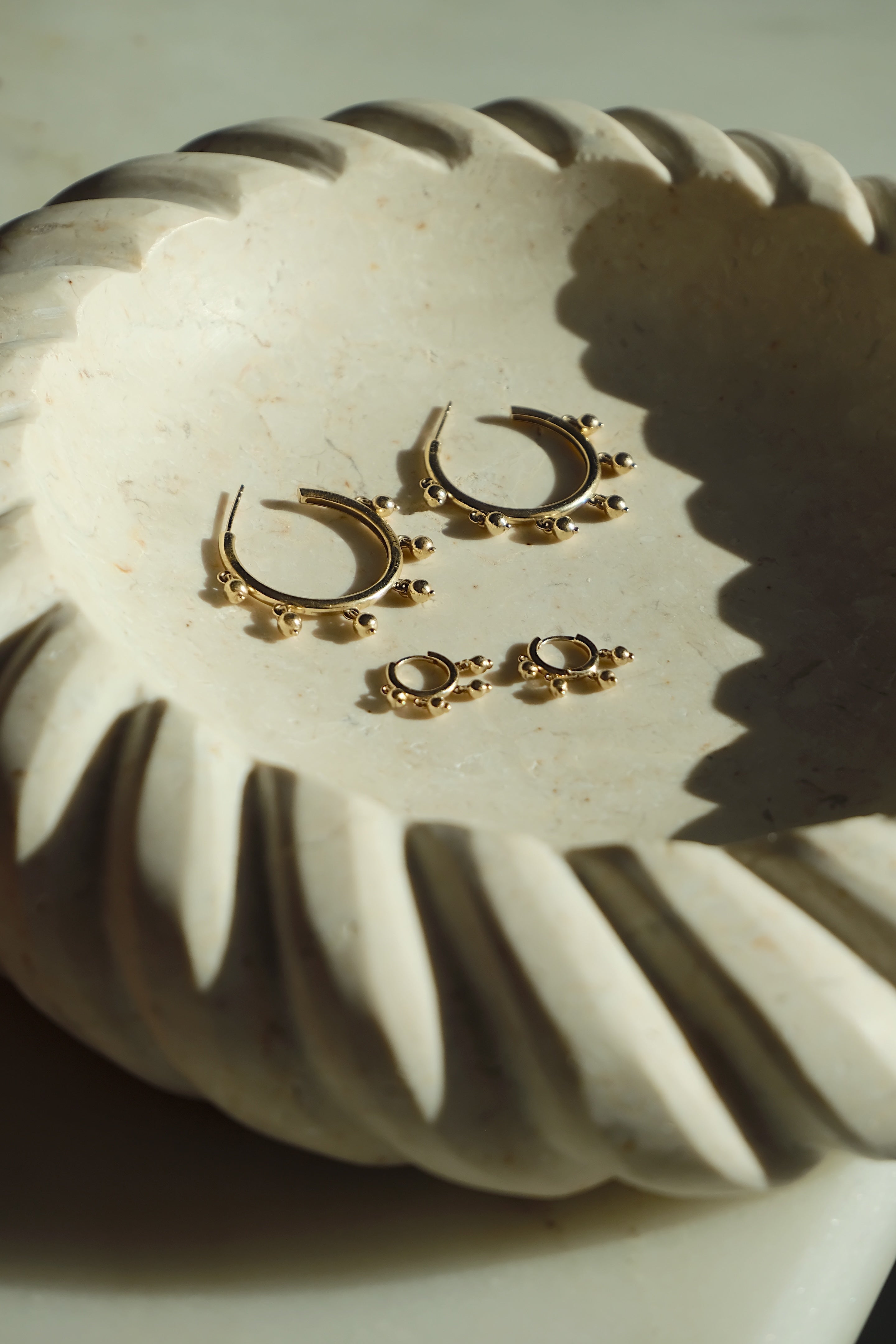 Hoops and Huggies in solid 14k gold – statement earrings with dangling gold beads inspired by Indian jhumkas