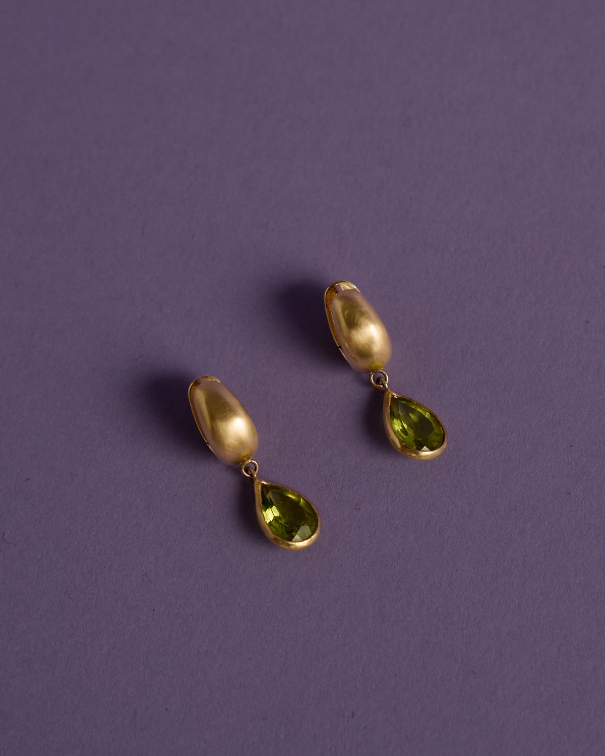 Malar Leaf Drops: pear peridot drop earrings in brushed 14k gold on lilac