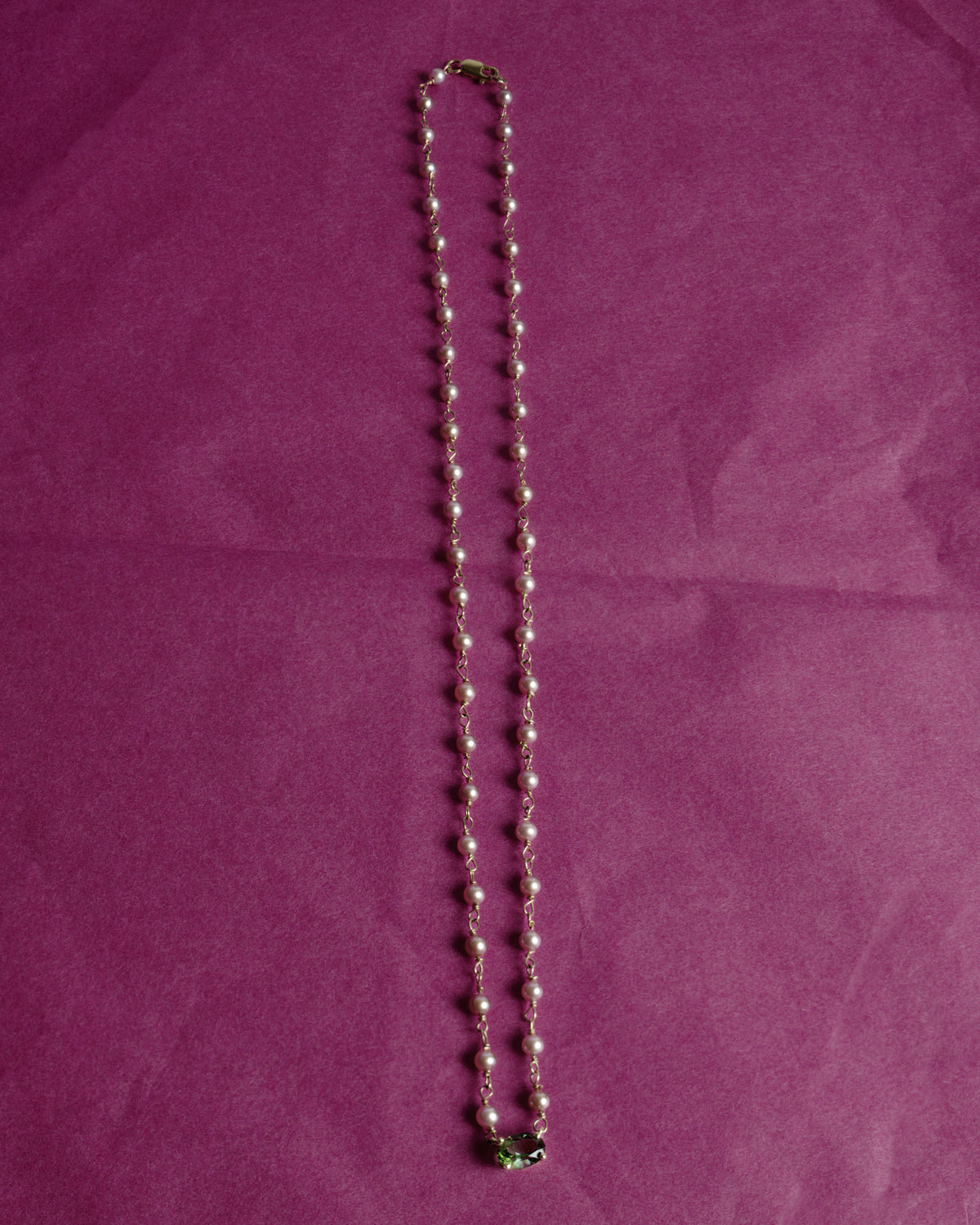 Malar Garland Necklace: full length of pink pearls hand-linked in 14k gold with a green tourmaline center