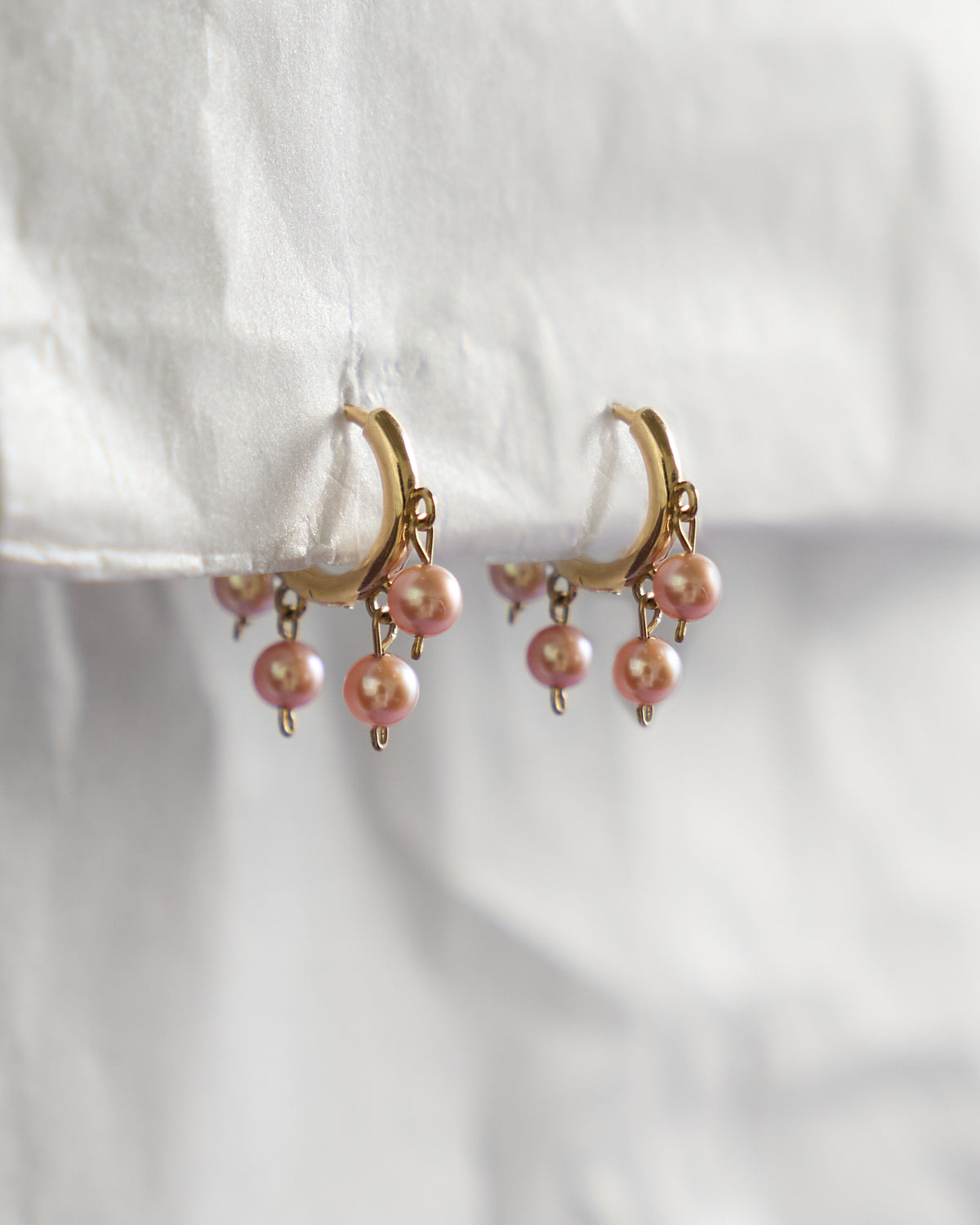 Malar Jhumka Hoops: pink pearl huggie earrings in solid 14k gold on white